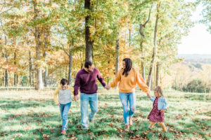 Family walking together through a park during outdoor photo session near Knoxville, TN