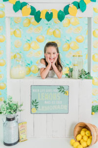 Girl posing at lemonade stand prop during Kingston studio photo session