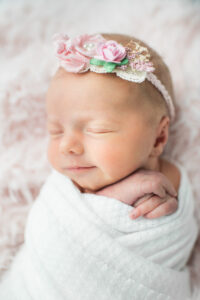 Newborn baby girl swaddled and sleeping, Knoxville newborn photography by HL Photos