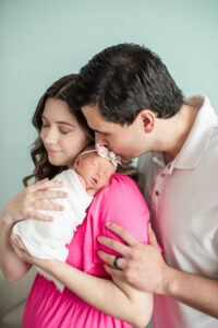 Father kissing newborn baby girl's forehead, Knoxville family newborn photography