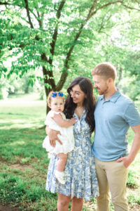 Mom and dad smiling at one-year-old Juliana, Harriman first birthday photography