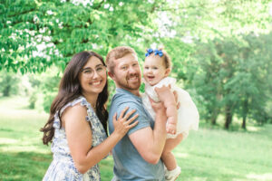 Family of three smiling at camera, Harriman first birthday photography