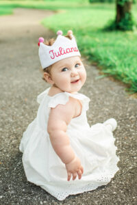 One-year-old Juliana smiling while wearing birthday crown, Harriman first birthday session