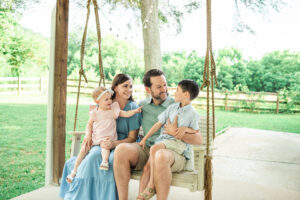 Family of four on porch swing outdoors, Knoxville family photography