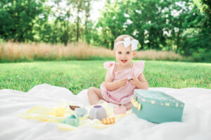 Toddler girl Gracie playing with her tea set outdoors, Knoxville family photography