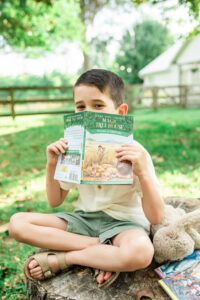 Six-year-old boy Beckett with his favorite books outdoors, Knoxville family photography