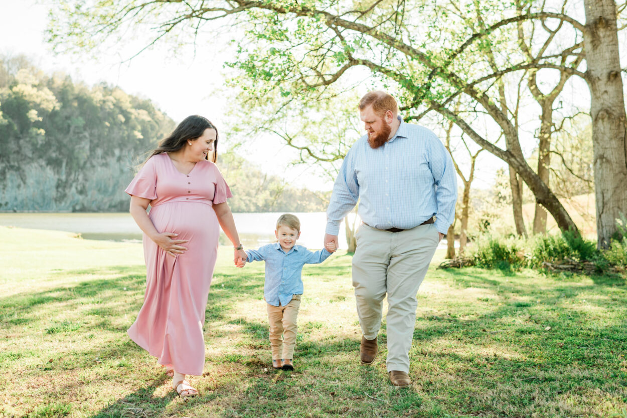 Nix family holding hands, wide shot at Melton Hill Park maternity session