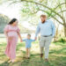 Nix family holding hands, wide shot at Melton Hill Park maternity session