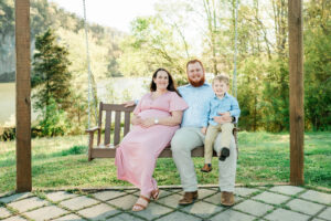 Nix family sitting together on swing, Melton Hill Park maternity session