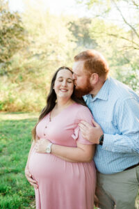Husband kissing wife's forehead, Knoxville maternity session