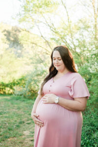 Mom looking down cradling baby bump, Knoxville maternity session