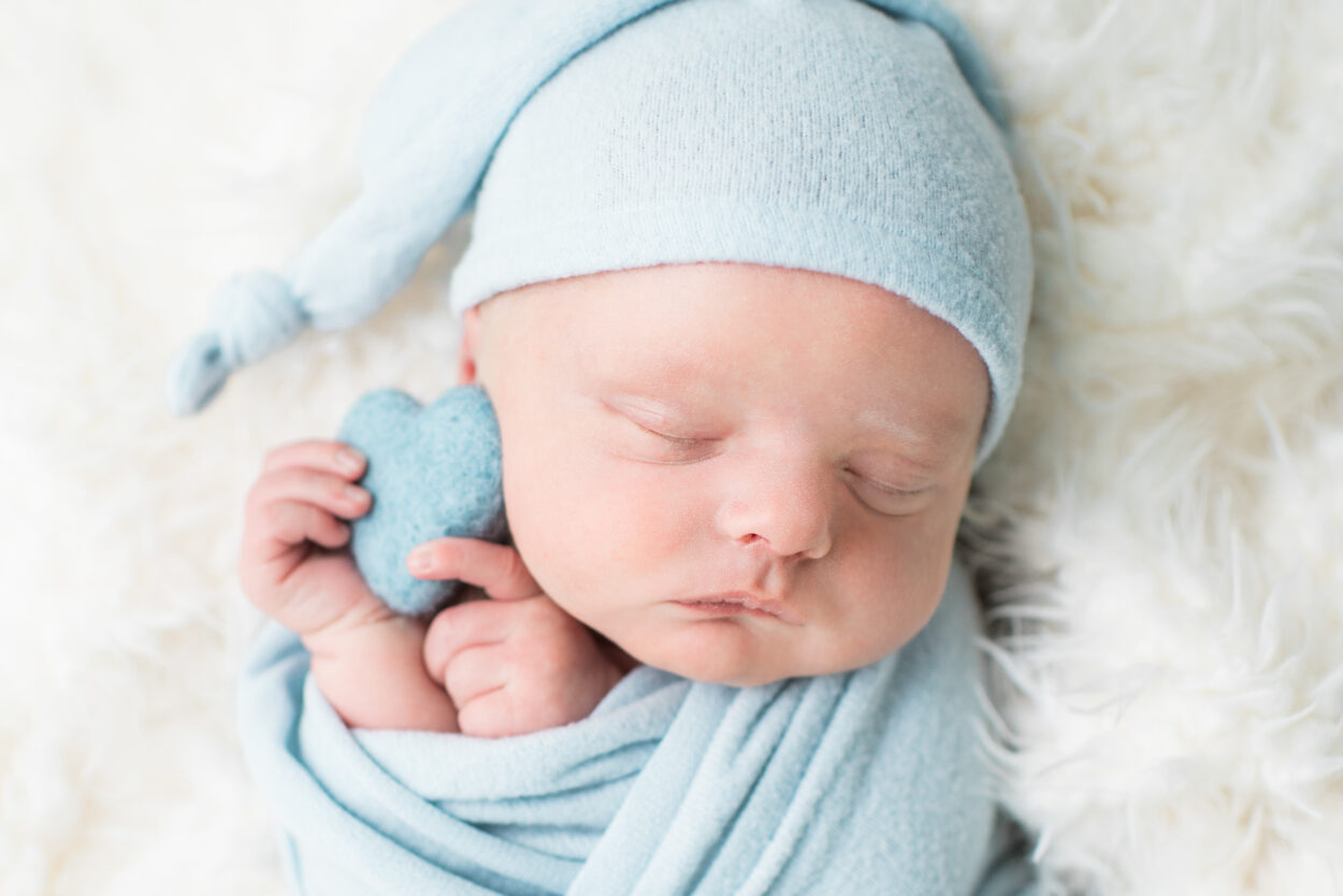 Close up newborn baby with blue heart prop, Knoxville newborn photography studio