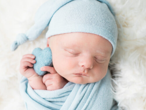 Close up newborn baby with blue heart prop, Knoxville newborn photography studio