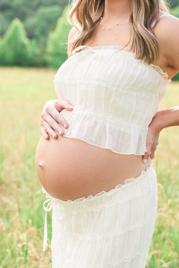 Pregnant mom cradling her baby bump during a maternity session at Lakeshore Park in Harriman, TN