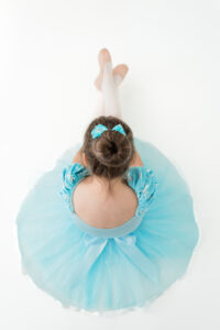 Young girl in blue snowflake ballerina dress during winter studio session in Kingston
