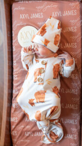 Newborn baby in buffalo onesie in hospital bassinet during Fresh 48 session