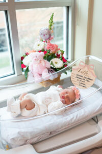 Newborn baby in hospital bassinet near window during Fresh 48 photo session