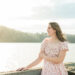 Senior girl in pink floral dress standing by a lake at golden hour, Knoxville senior photographer lakeside session
